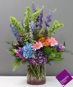 This arrangement is designed with a wide variety of beautiful flowers including roses, orchids, gerbers and more.