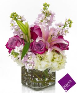  bouquet, a cube vase with whites, pinks, and Lavenders..