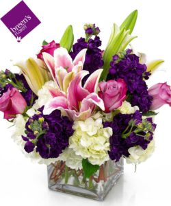 pink and white lilies with purple and white flowers in vase
