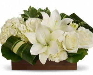 Lovely and serene as a Zen garden, this exquisite bouquet of white roses, lilies and hydrangea in a natural bamboo vase is a gift of love that will be long remembered. 