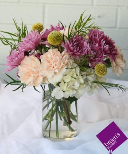 For those who love pastels, this delightful bouquet of pastel florals accented with textures is the perfect gift. Colors may vary.